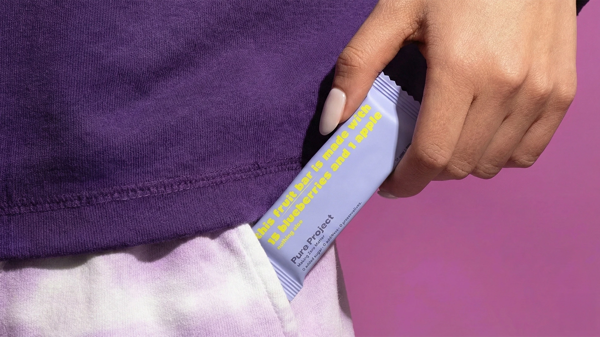 Minimal lifestyle composition showcasing Pure Project fruit bar packaging