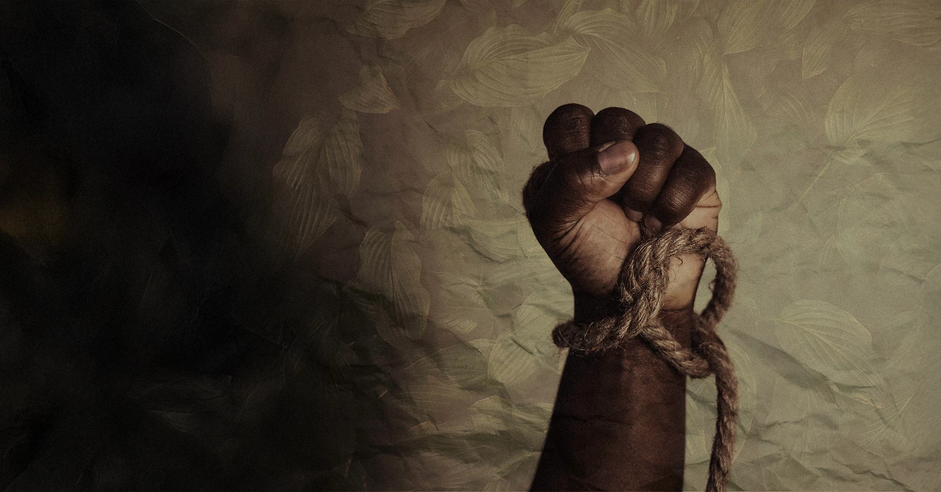 A clenched fist with a knotted rope around the wrist.