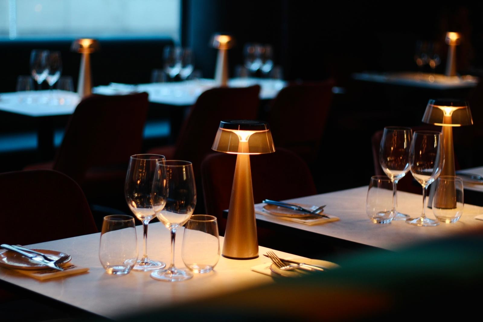 A woman sitting at a bar with a wine glass