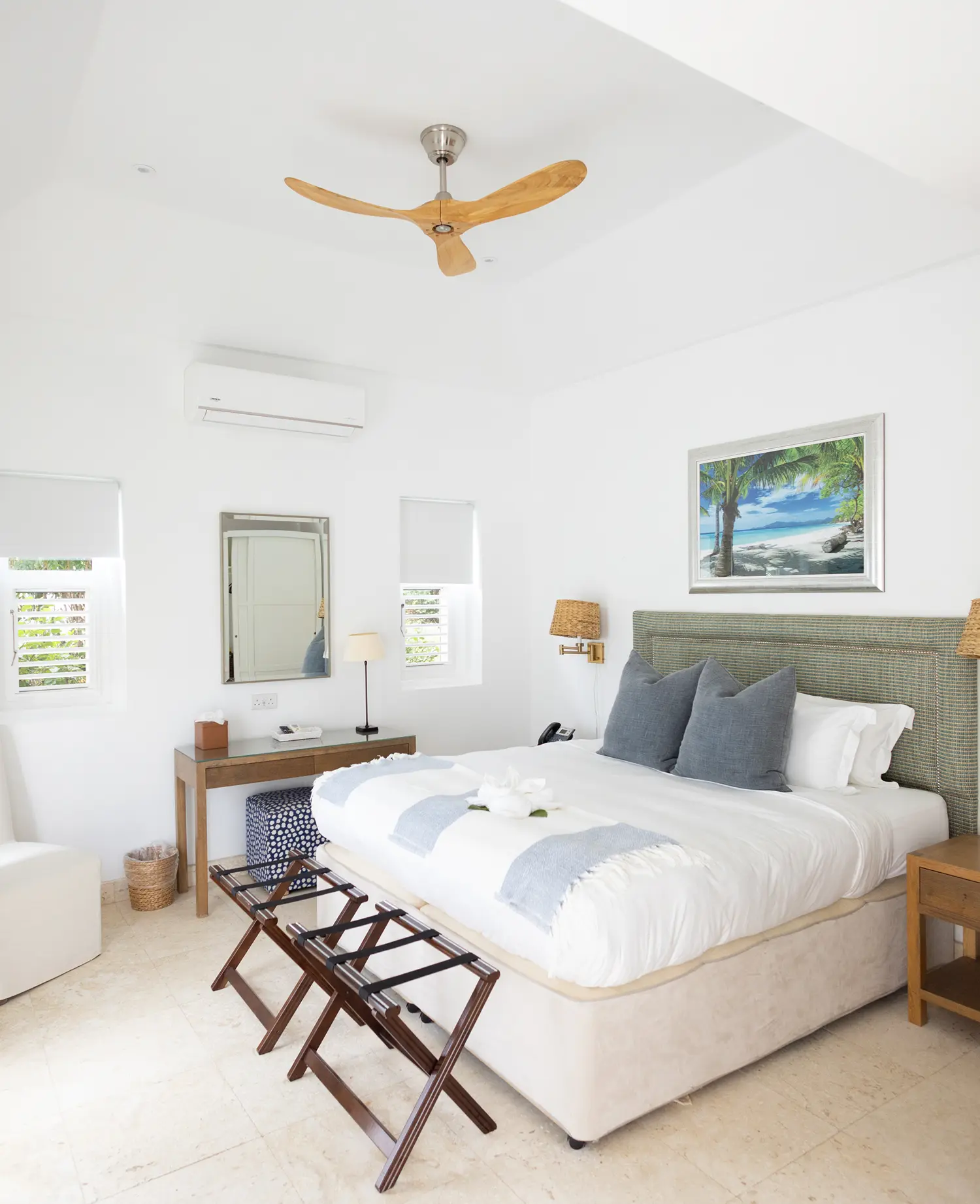 Colorful overhead spread of tropical fruits including watermelon, bananas, papaya, citrus, and fresh flowers arranged on a woven mat