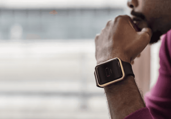 A smartwatch on a charging puck, illustrating battery life