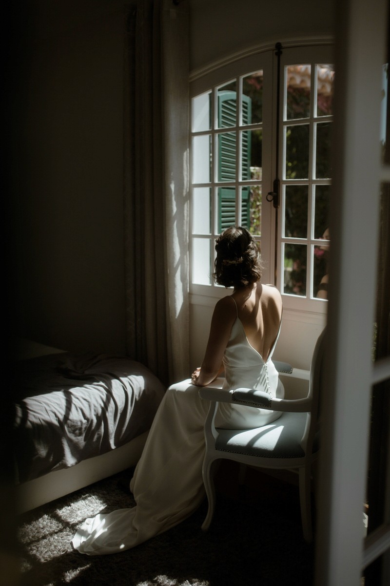 bride getting ready in soft window light