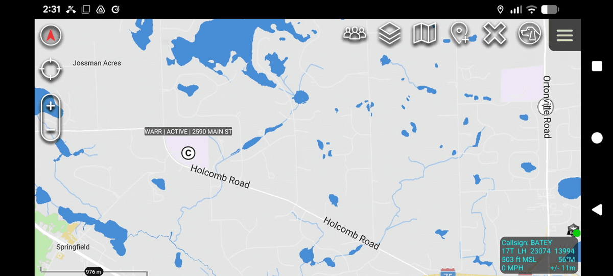A mobile map application displaying CAD data with flood risk areas marked in blue across a landscape near Springfield and Otombie Road.
