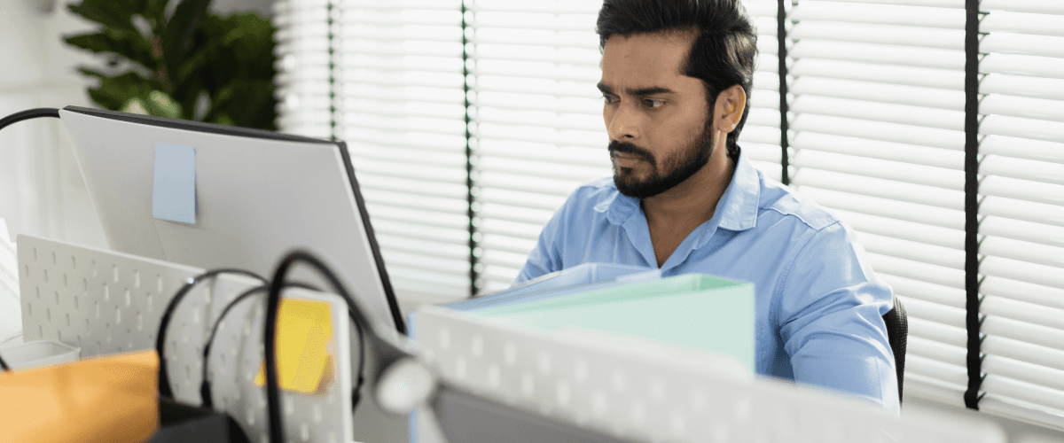A business professional looking thoughtfully at a computer screen, representing the use of animated explainer videos to understand difficult business concepts.