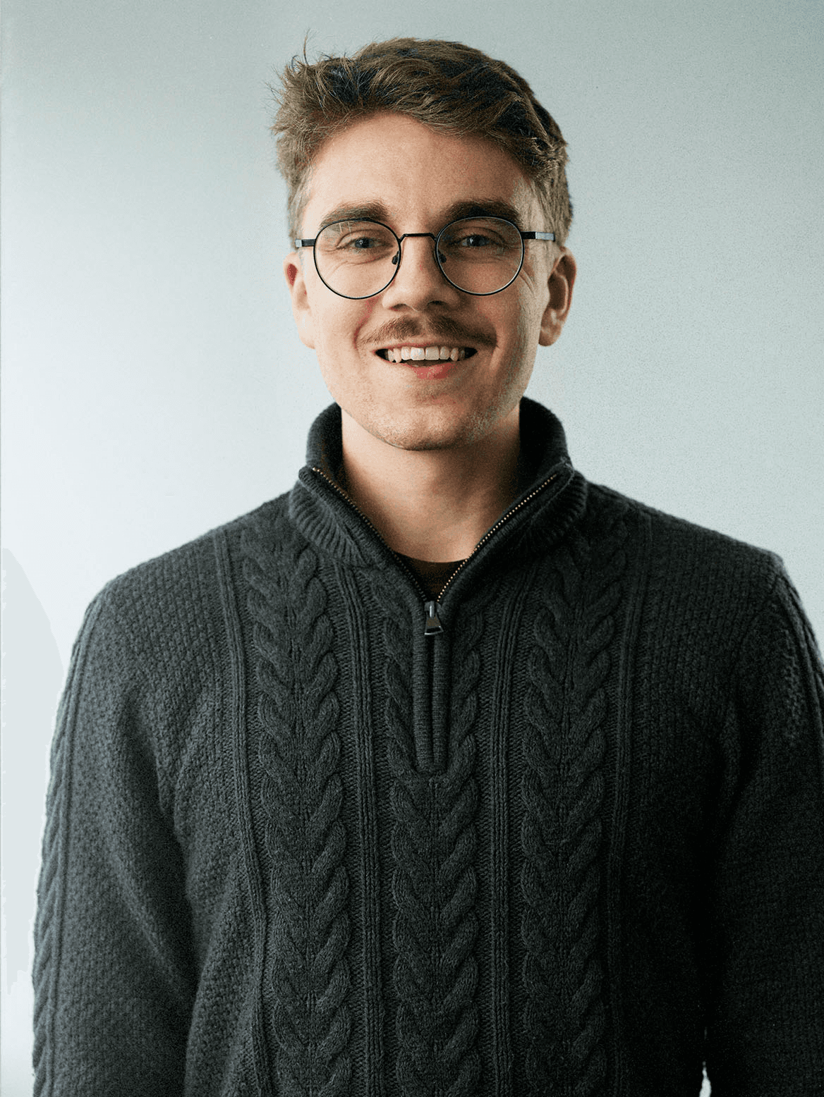 man standing beside wall