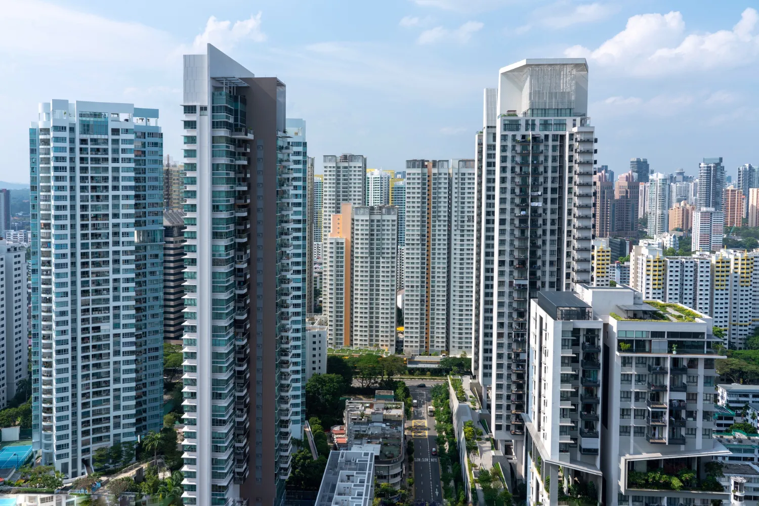 Residential towers, standing tall among several buildings in the cityscape.