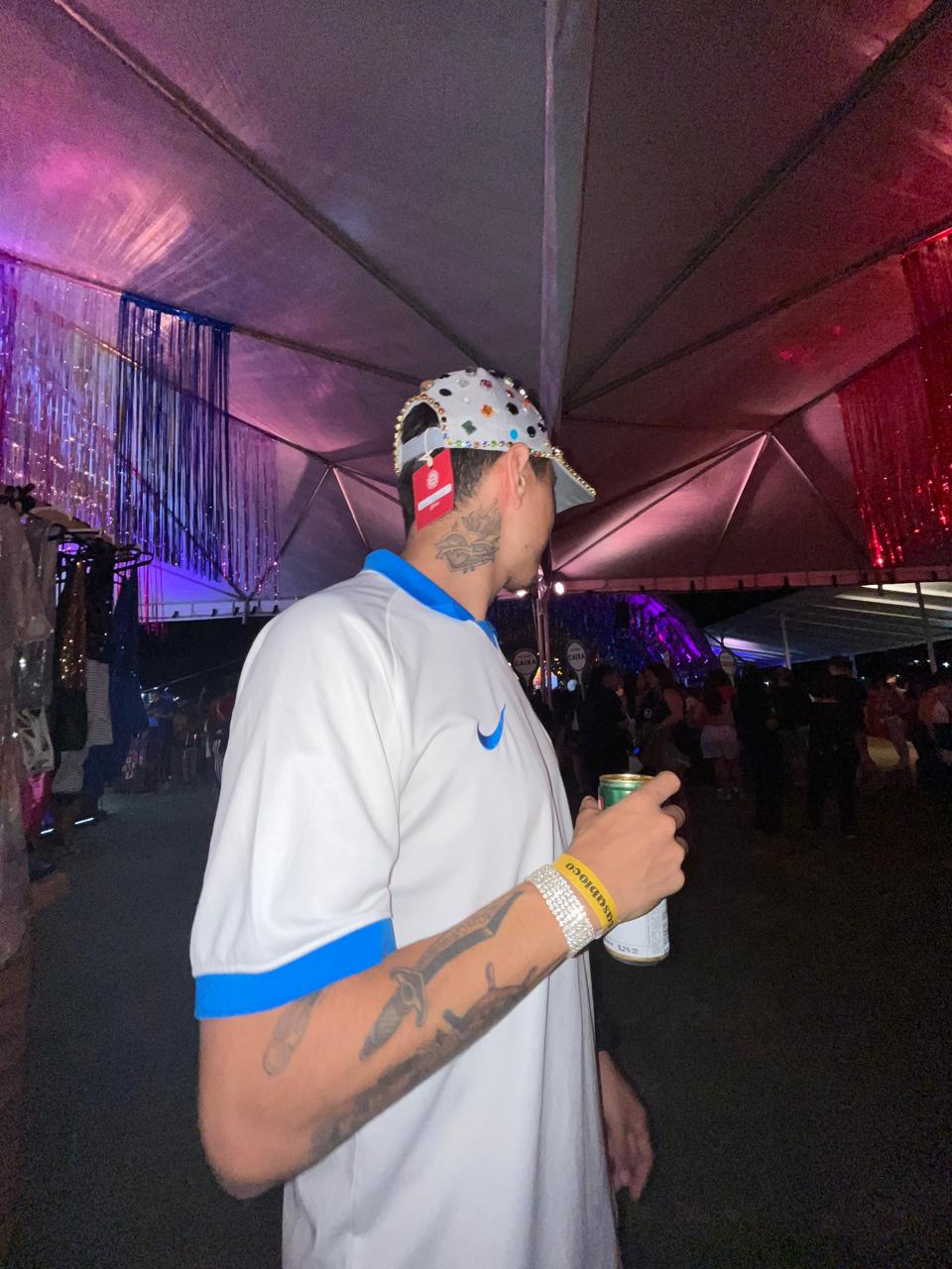 A thoughtful young person with dark hair gazes to the side, captured in soft black and white lighting.