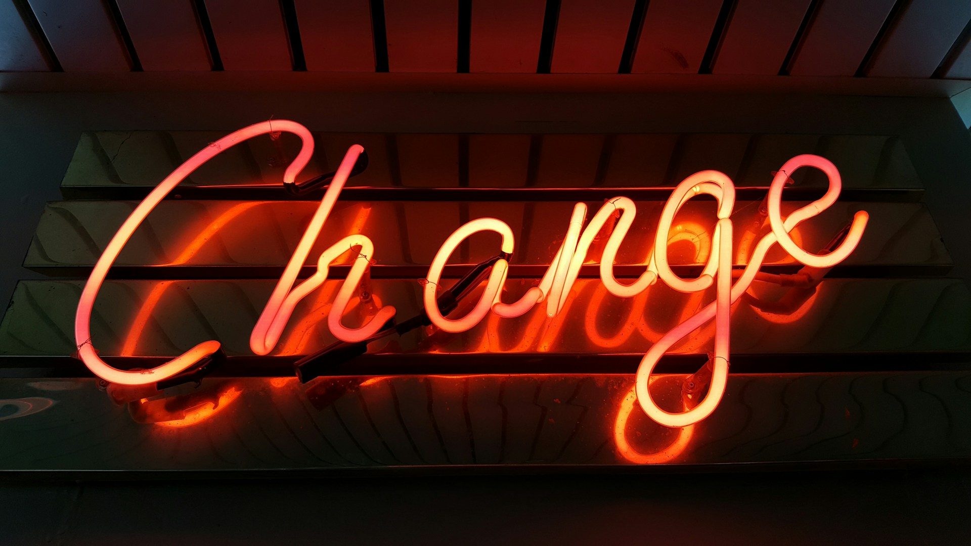 This image shows a neon sign that spells the word 'Change' in glowing red and orange lights. It serves as the hero image for the blog on the Rarecide website, discussing 'The Role of Social Media in Driving Business Transformation.' Rarecide, a leading social media management and marketing agency, specializes in social media marketing, marketing strategy development, and innovative approaches to business growth. Known as the best-rated social media marketing company in Toronto, Rarecide is recognized for its high-ranking marketing strategies and expertise in customer acquisition and retention.