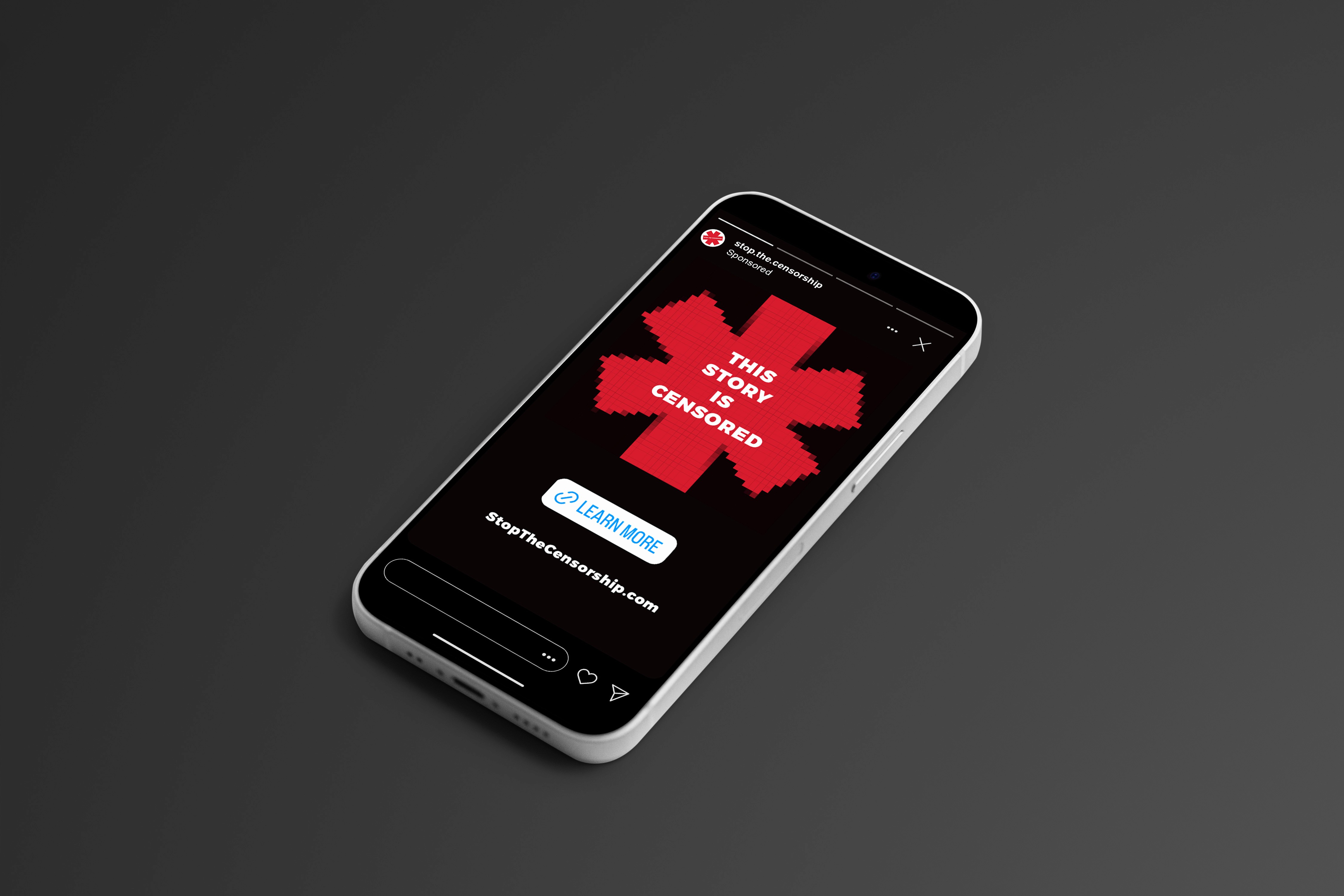 An advertisement on a phone saying 'stop the censorship,' on a bright red, pixelated asterisk