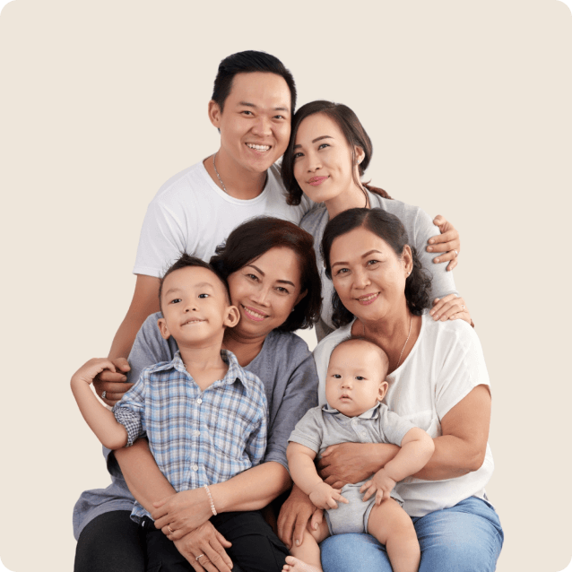 Portrait of a happy family gathered in their kitchen after participating in a nutrition culture program. They are preparing a healthy meal together, showcasing fresh fruits and vegetables on the counter. Each family member has a joyful expression, reflecting their commitment to healthier eating habits and a supportive lifestyle change.