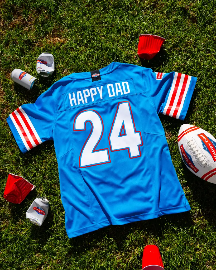 MrBeast, a young man with short hair wearing a black t-shirt, looking thoughtfully to the side against a gray background.