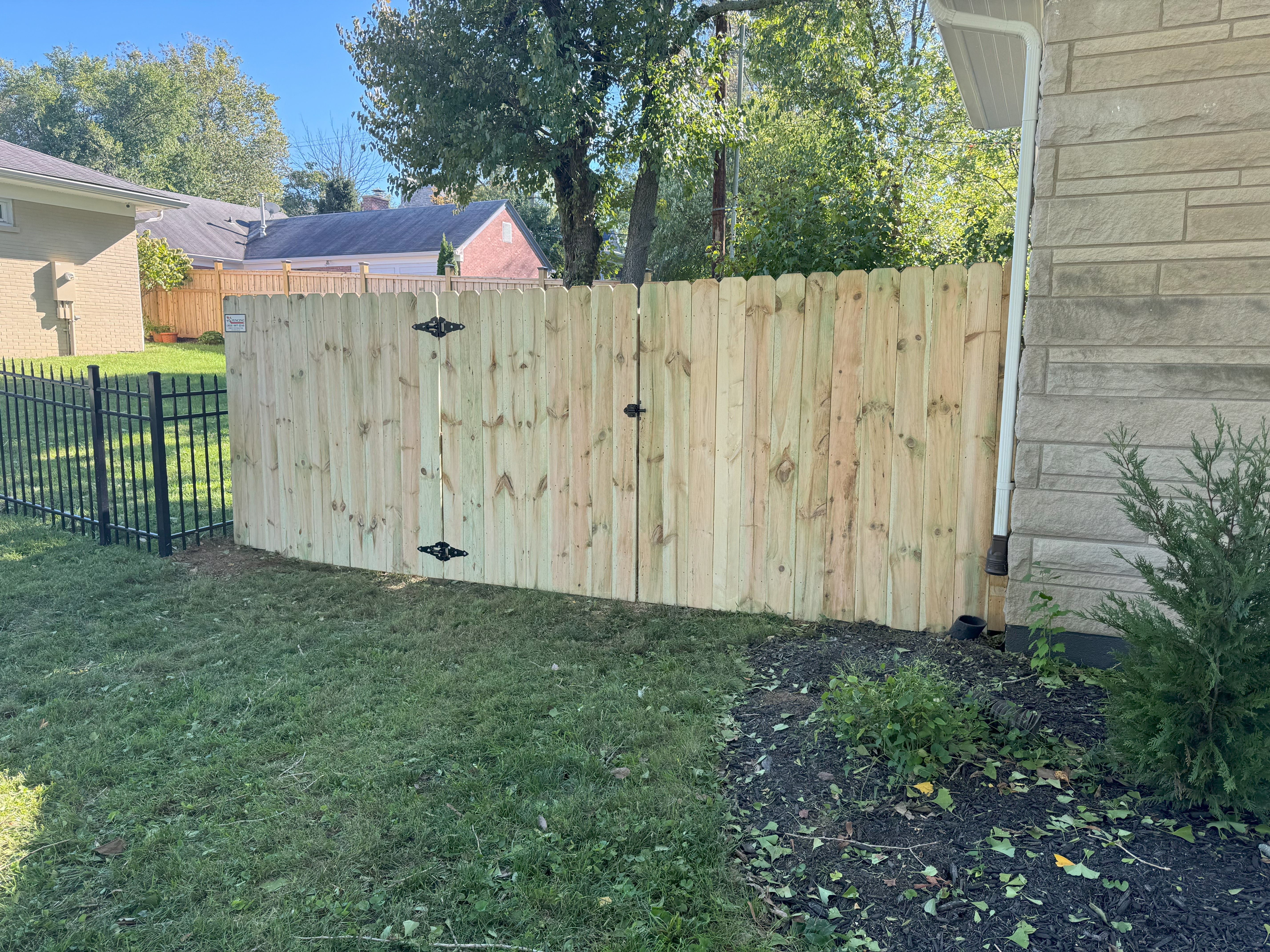 Covered back porch with wood posts and brick trim
