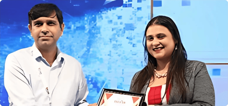 Pic of founder collecting ET Education Symposium award