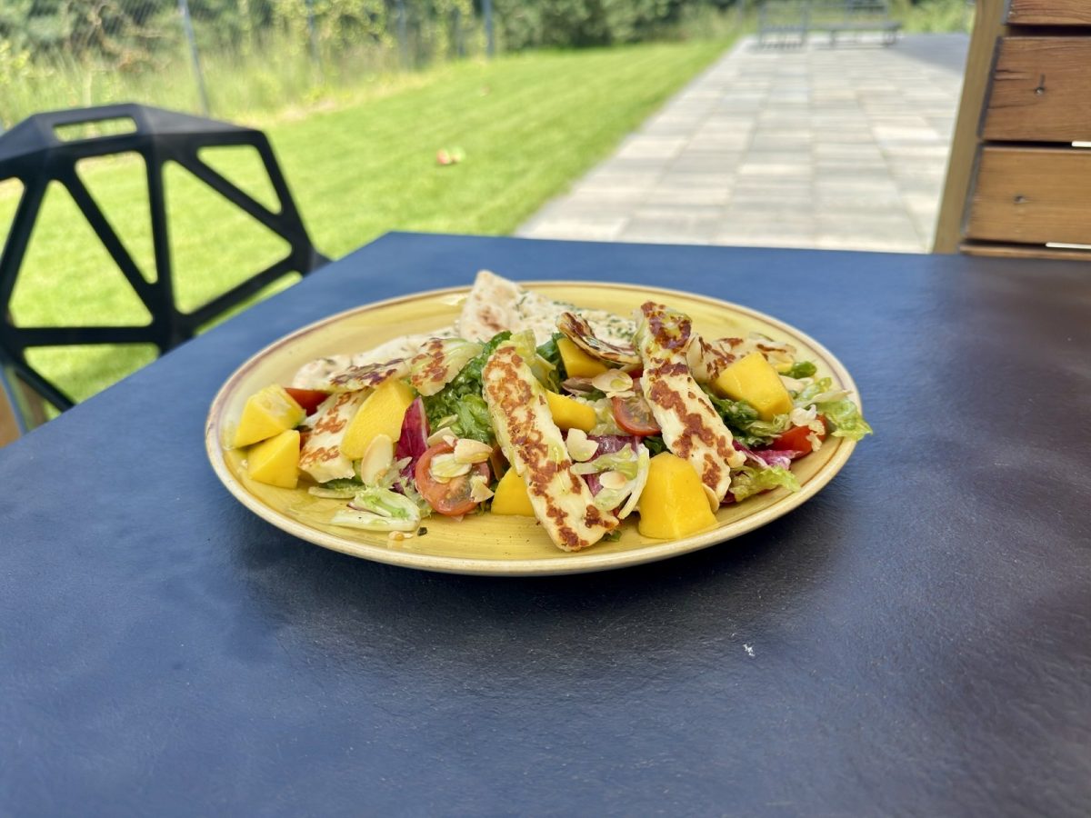 Sałatka z serem i warzywami podana na tarasie restauracji