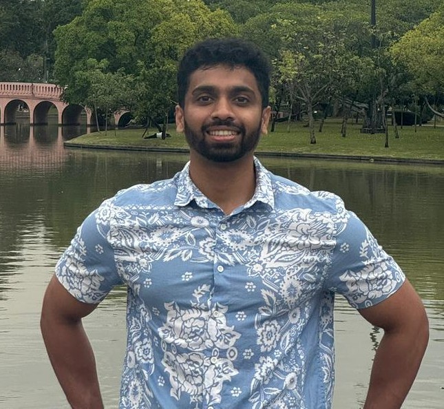 woman standing by wall holding mug