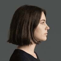 woman in white crew neck shirt smiling