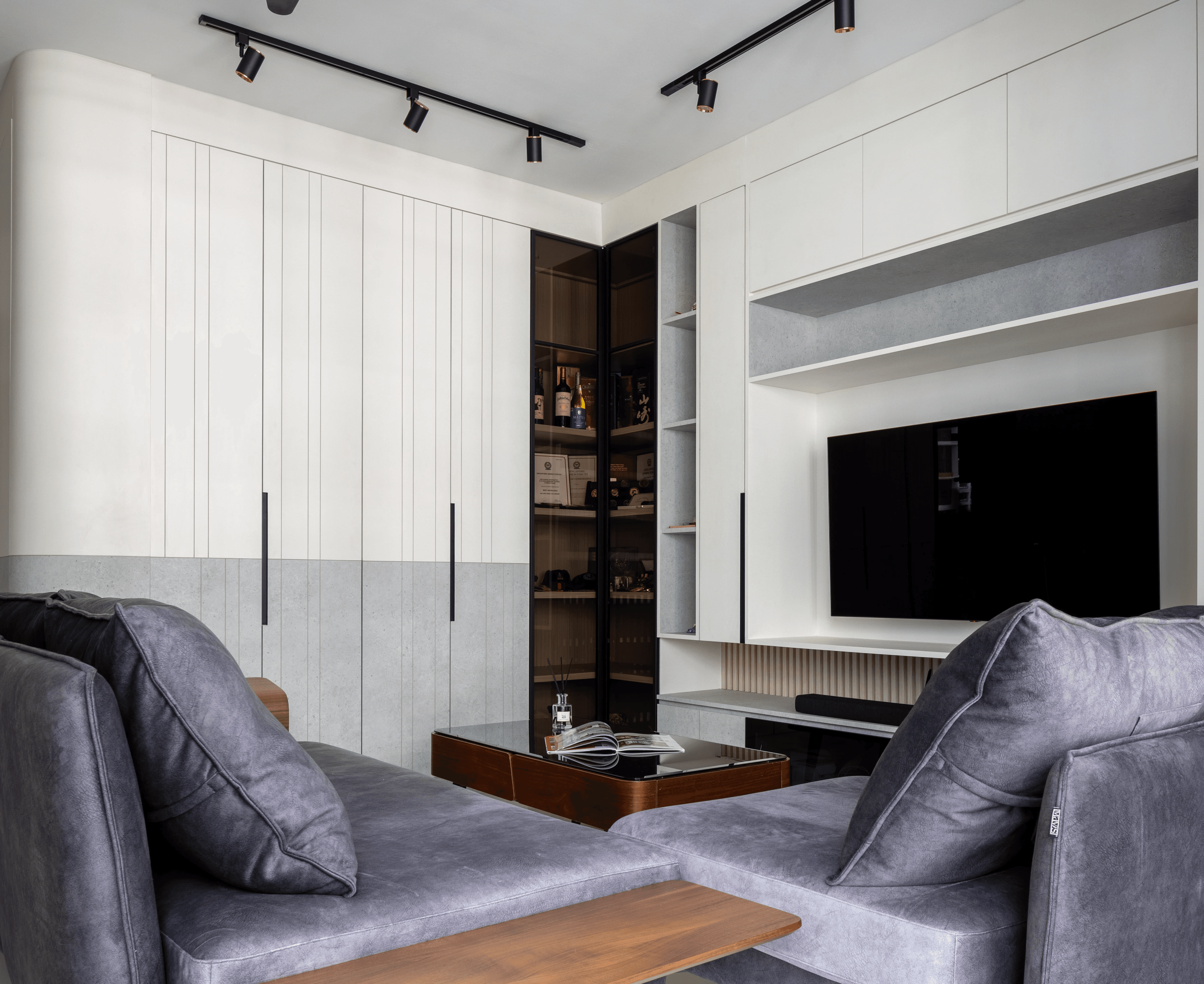 Dining nook with terrazzo-style table and leather chairs, framed by mirrored cabinetry and warm wood.
