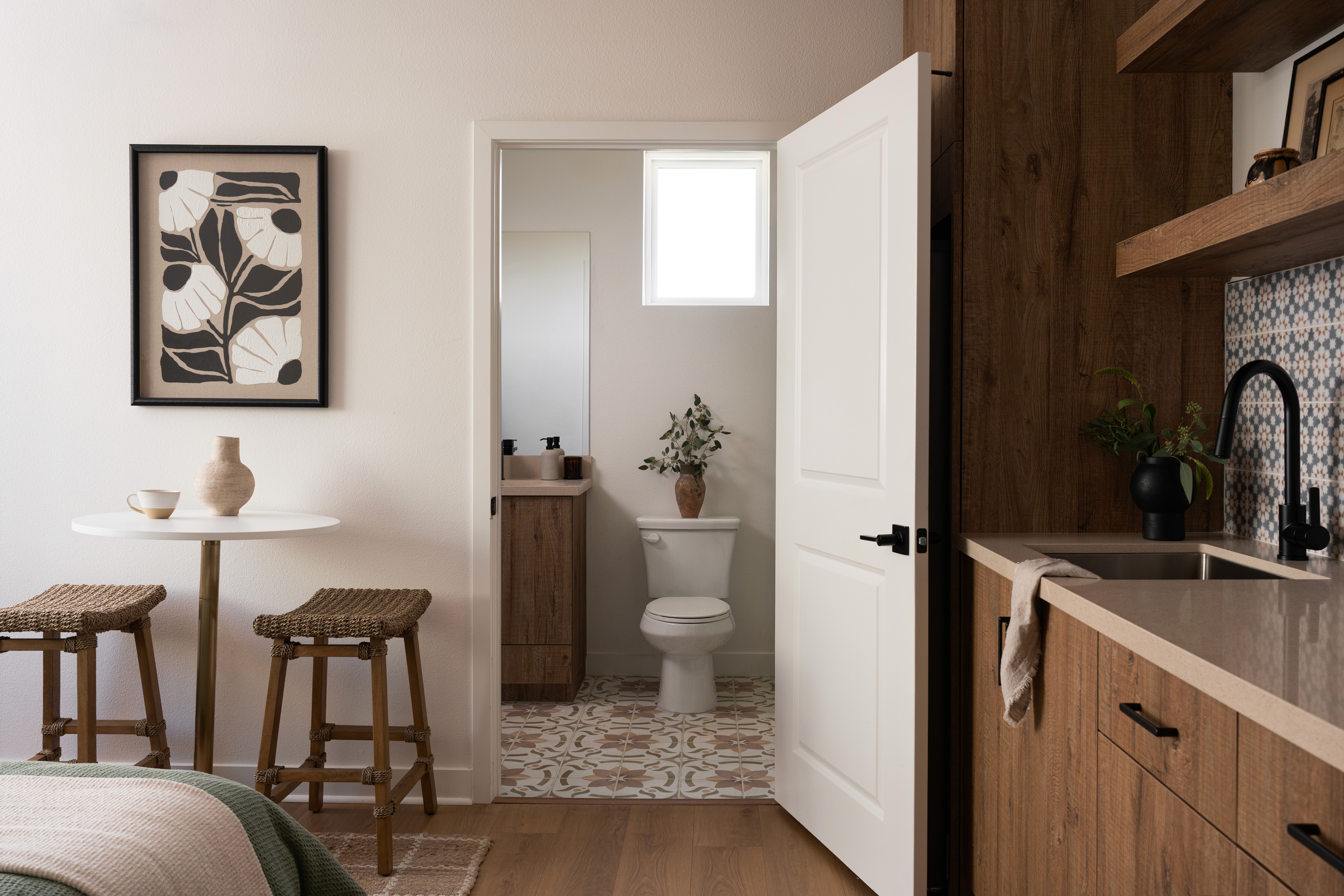 In Law/Guest Room with view of sink, bed, table and entry to bathroom from doorway of room
