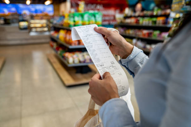 Retiree investingating grocery bill amidst inflation