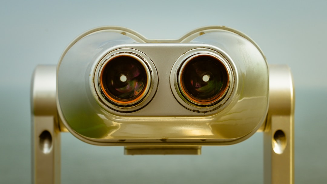 Here's a caption for the image: binoculars offer a close-up view.