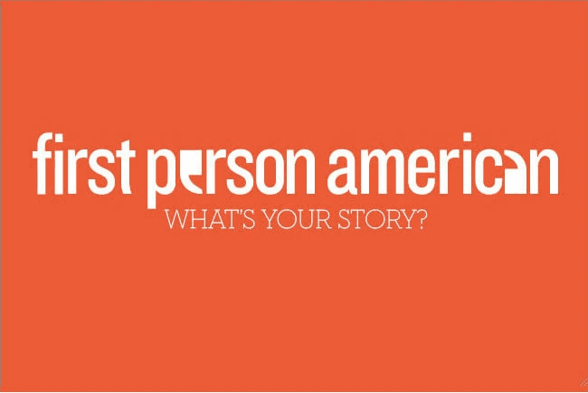 A screenshot of the First Person American website displaying a headline that reads "STORIES OF PEOPLE COMING TO AMERICA," accompanied by a photo of a man in a suit and an article about someone's experience growing up in Koza and their journey to Idaho.