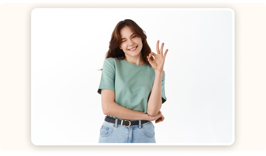 Smiling woman winking and making okay gesture with hand