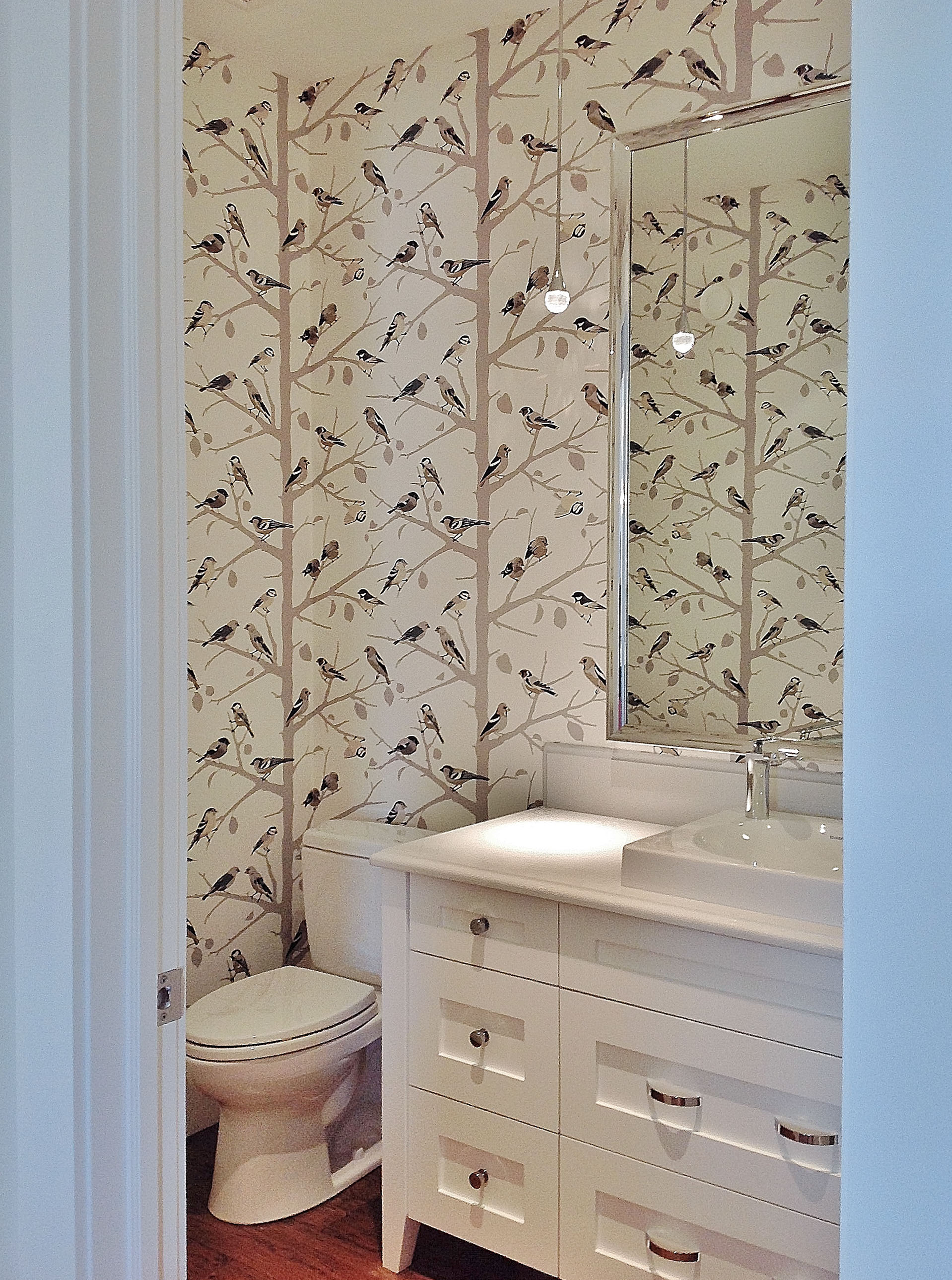 Image of KHD Homes bathroom design with wallpaper, modern sink, and toilet in a primary ensuite renovation.
