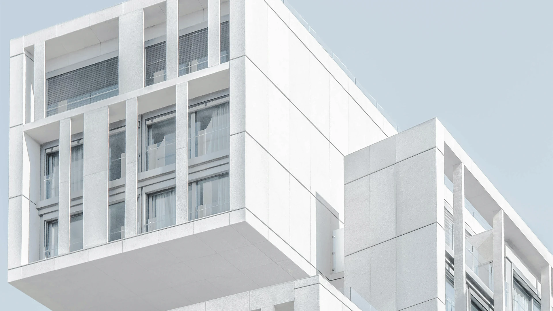 white modern cement building under blue sky