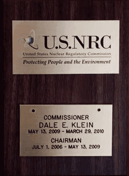 A plaque displaying the U.S. Nuclear Regulatory Commission's mission statement and certification dates.
