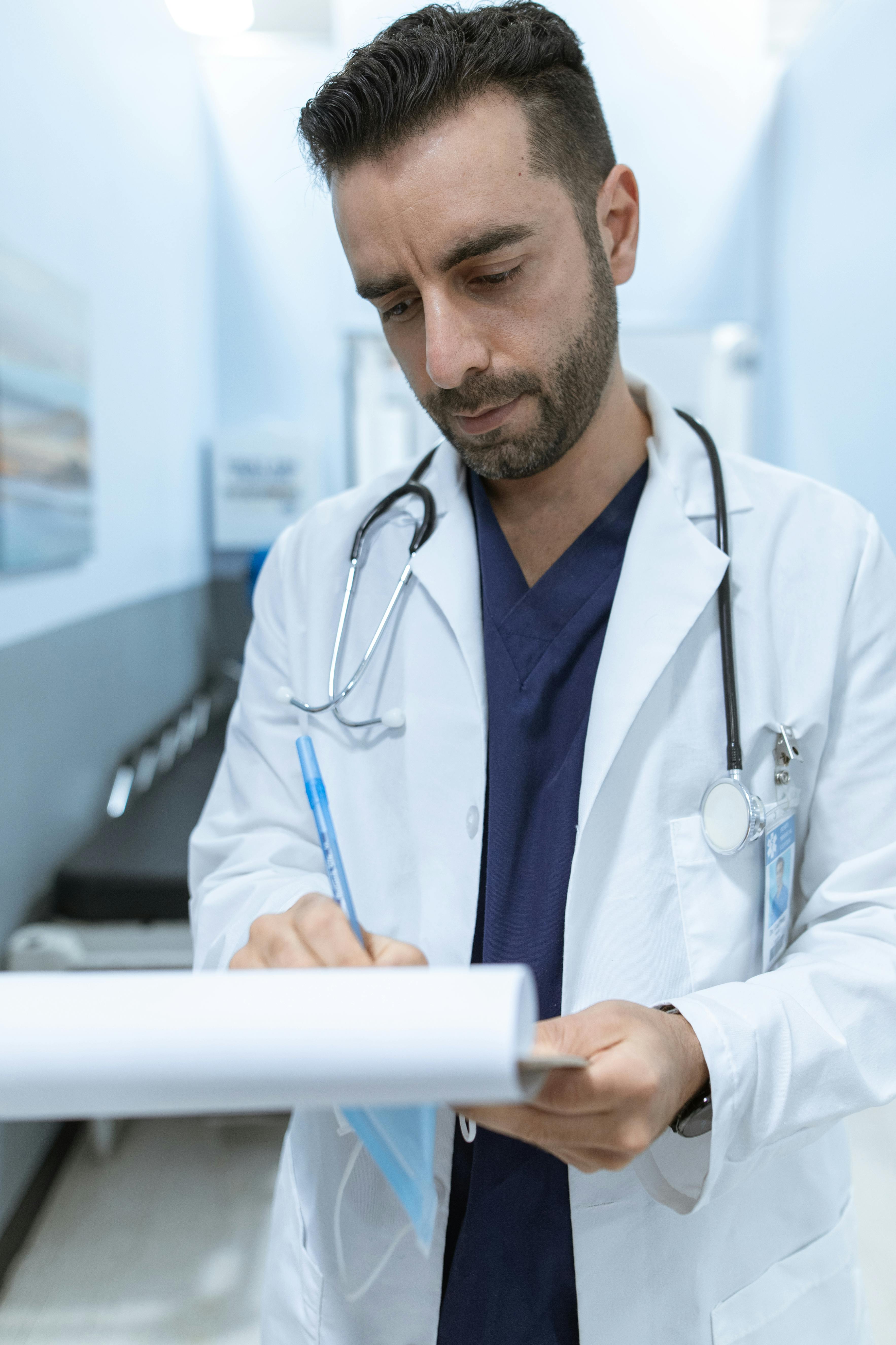 A picture ofDoctor writing bills on clipboard in medical clinic setting