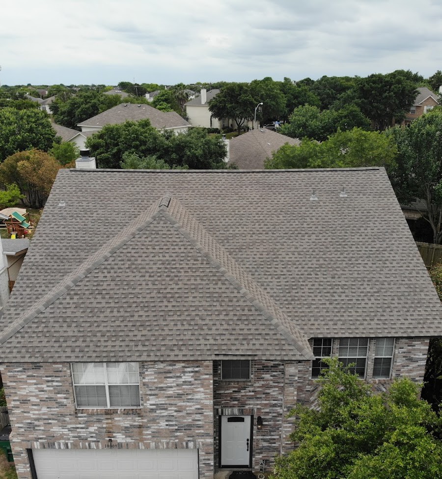 Large GAF HDZ architectural shingle roof with a chimney and dormers, combining durability and visual appeal in a classic design.