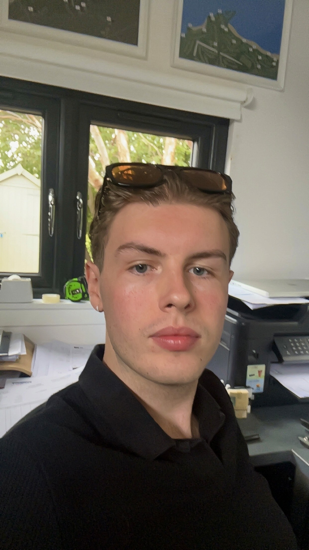 Monochrome product shot: black-capped cosmetic bottle with dynamic water splash on a clean white background.