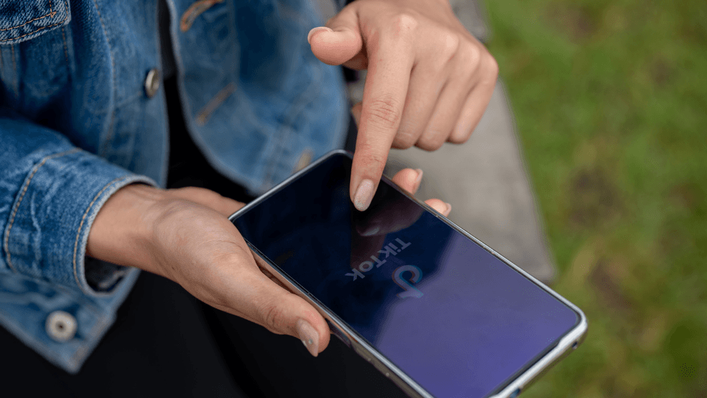 A Malaysian business owner using TikTok on her phone