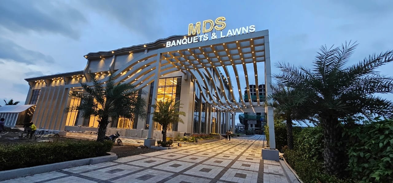 Outdoor restaurant terrace overlooking a tranquil lake at sunset. White tables and chairs are set with glassware. Sheer curtains add elegance. Calm ambiance.