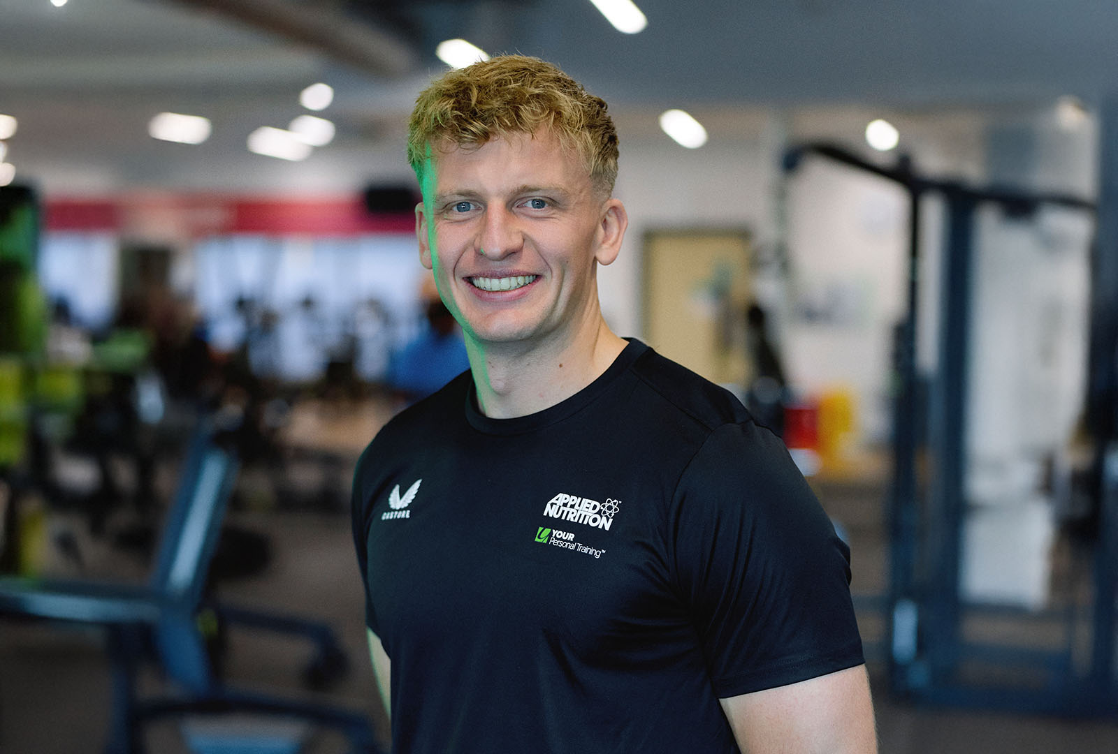 Close-up of lush, dark green leaves, some glossy and wet, against a muted background.