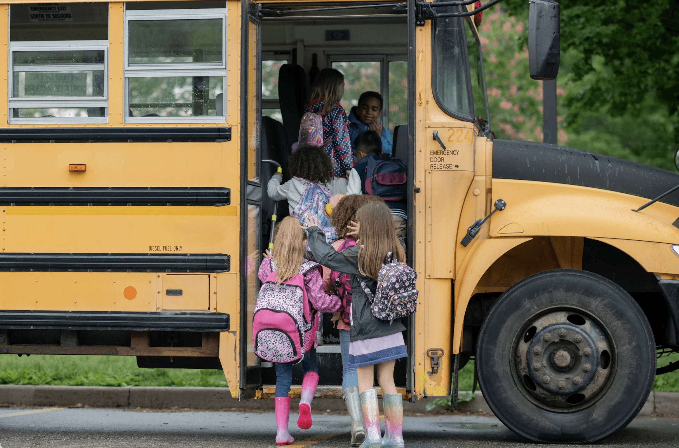 young children stepping onto a school bus