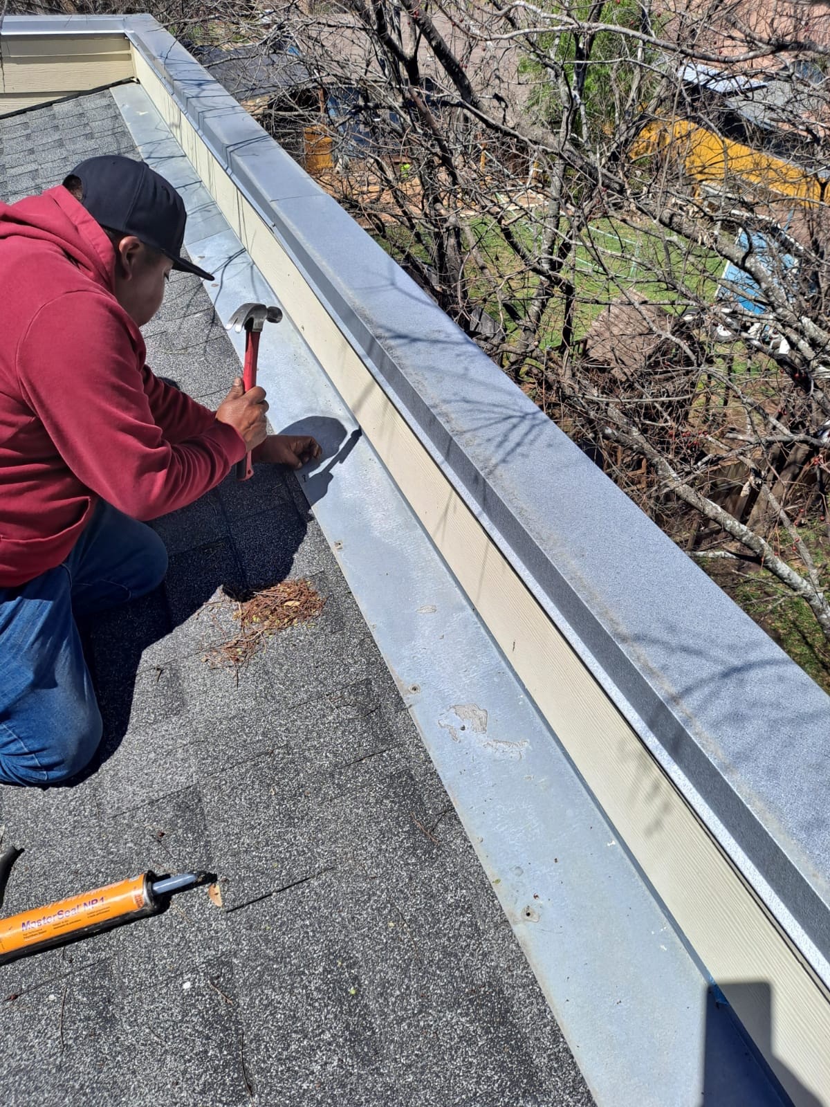 Flashing on a shingle roof being fixed by our worker after roof inspection. 