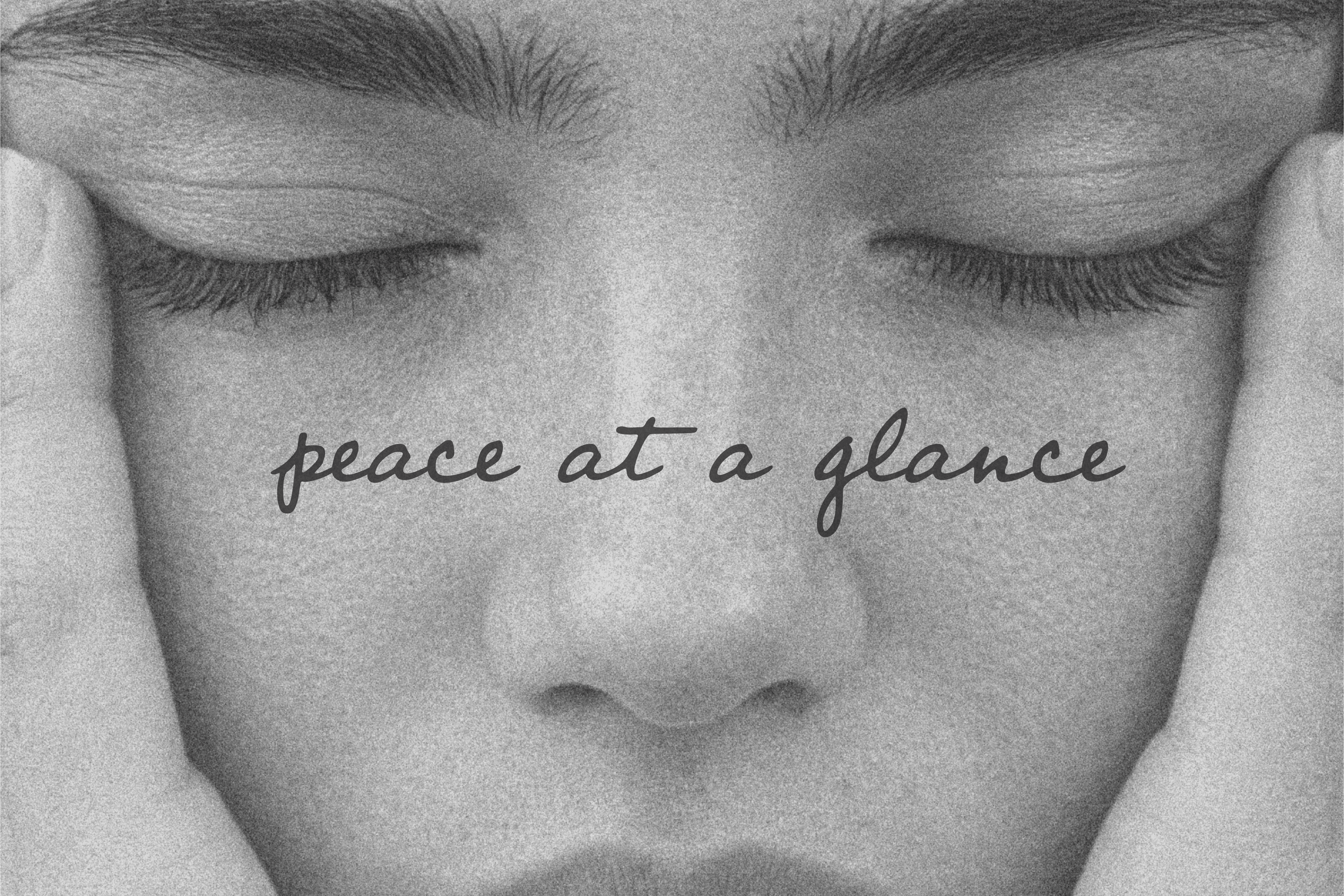 Black-and-white close-up of a person cupping their own face, eyes closed