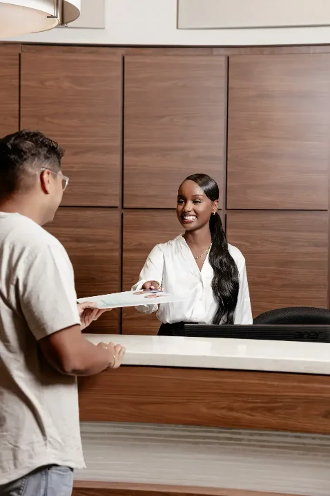 Patient receiving treatment forms at ScarboroSmiles: Best dentist in Scarborough, Ontario