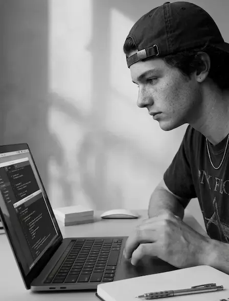 A individual works intently on a laptop