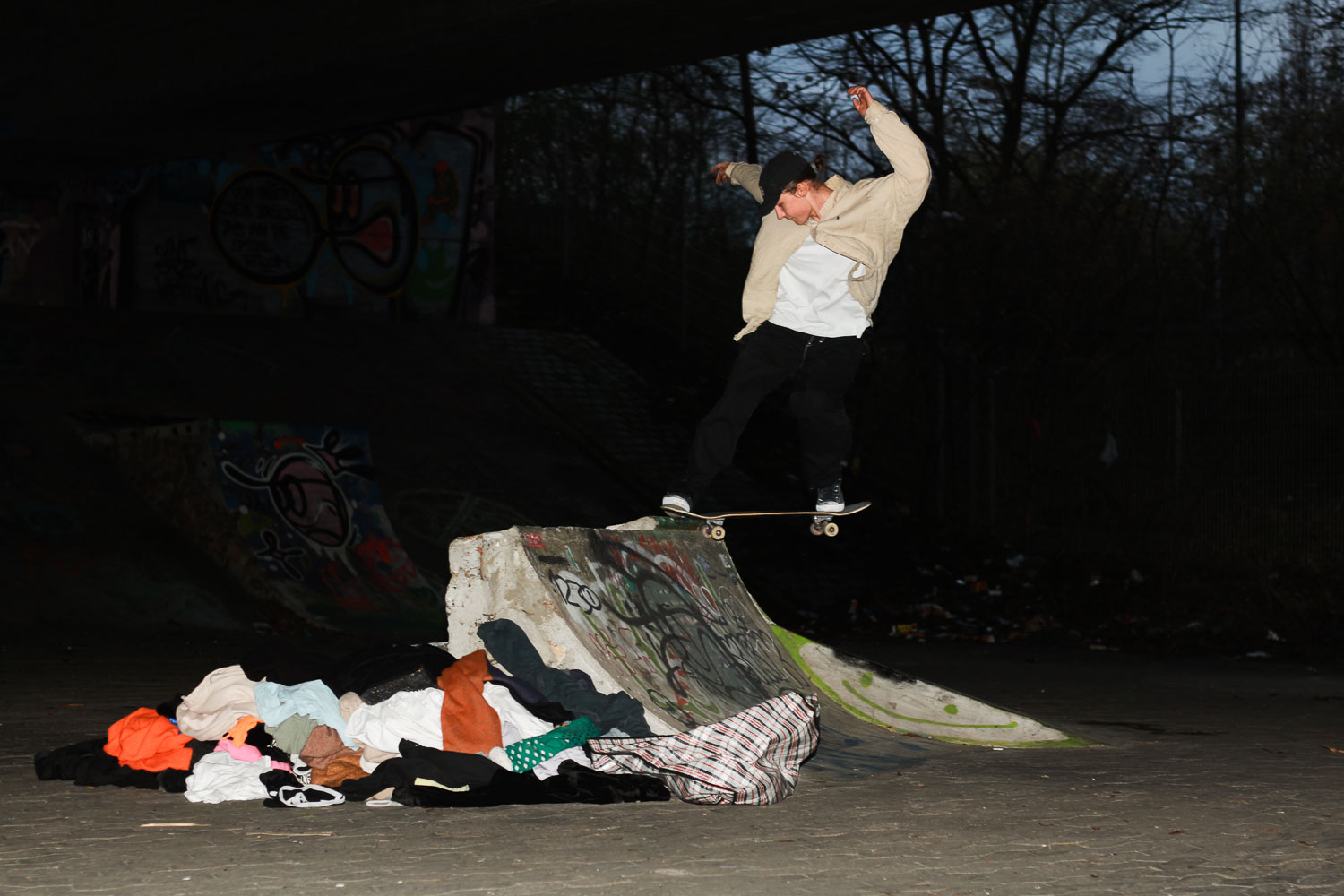 skateboard trick under a bridge