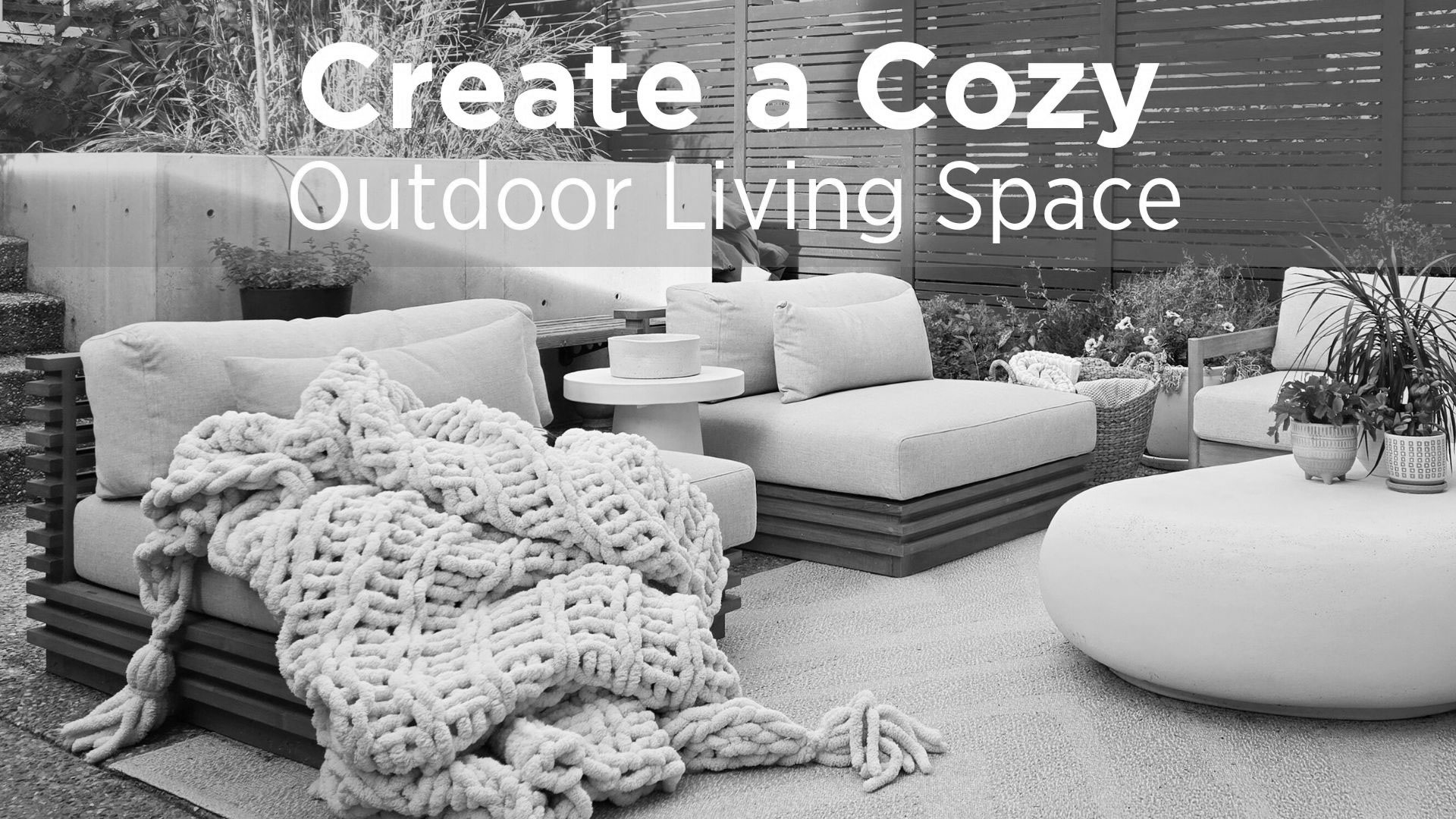 A cozy patio with cushy chairs and cozy blankets.