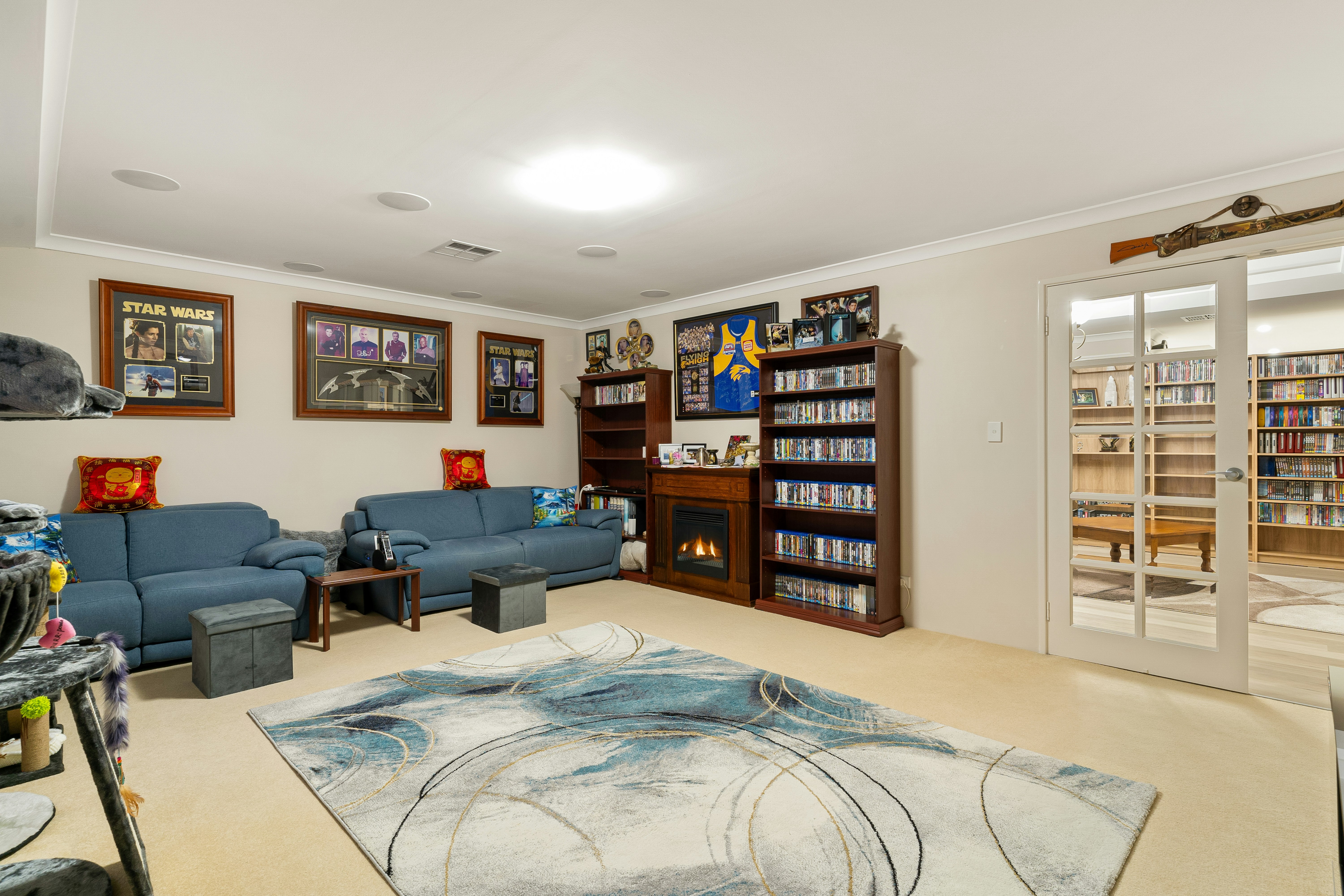 A living room filled with furniture and a book shelf