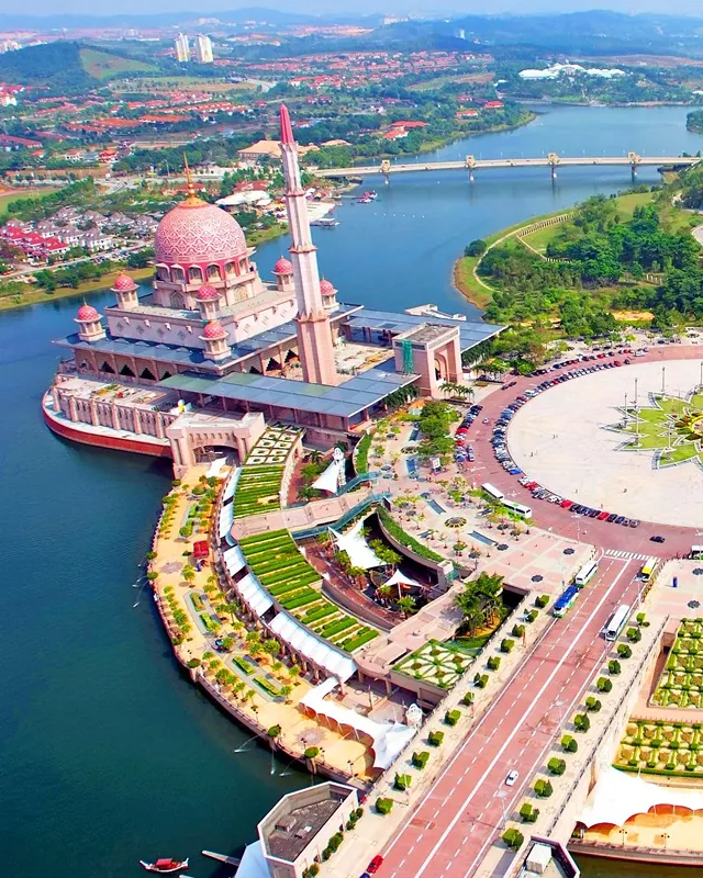 Palm trees frame a dramatic mountain valley landscape