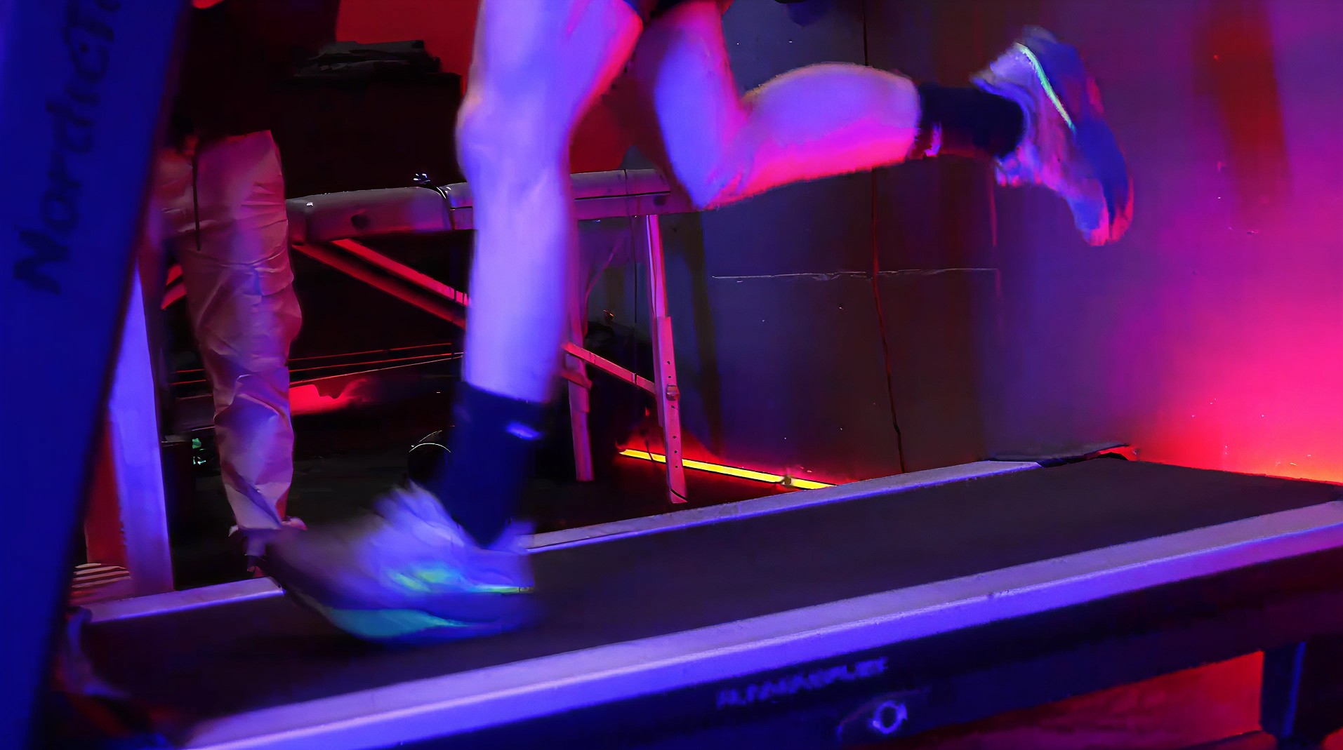 A woman running on a running track at night