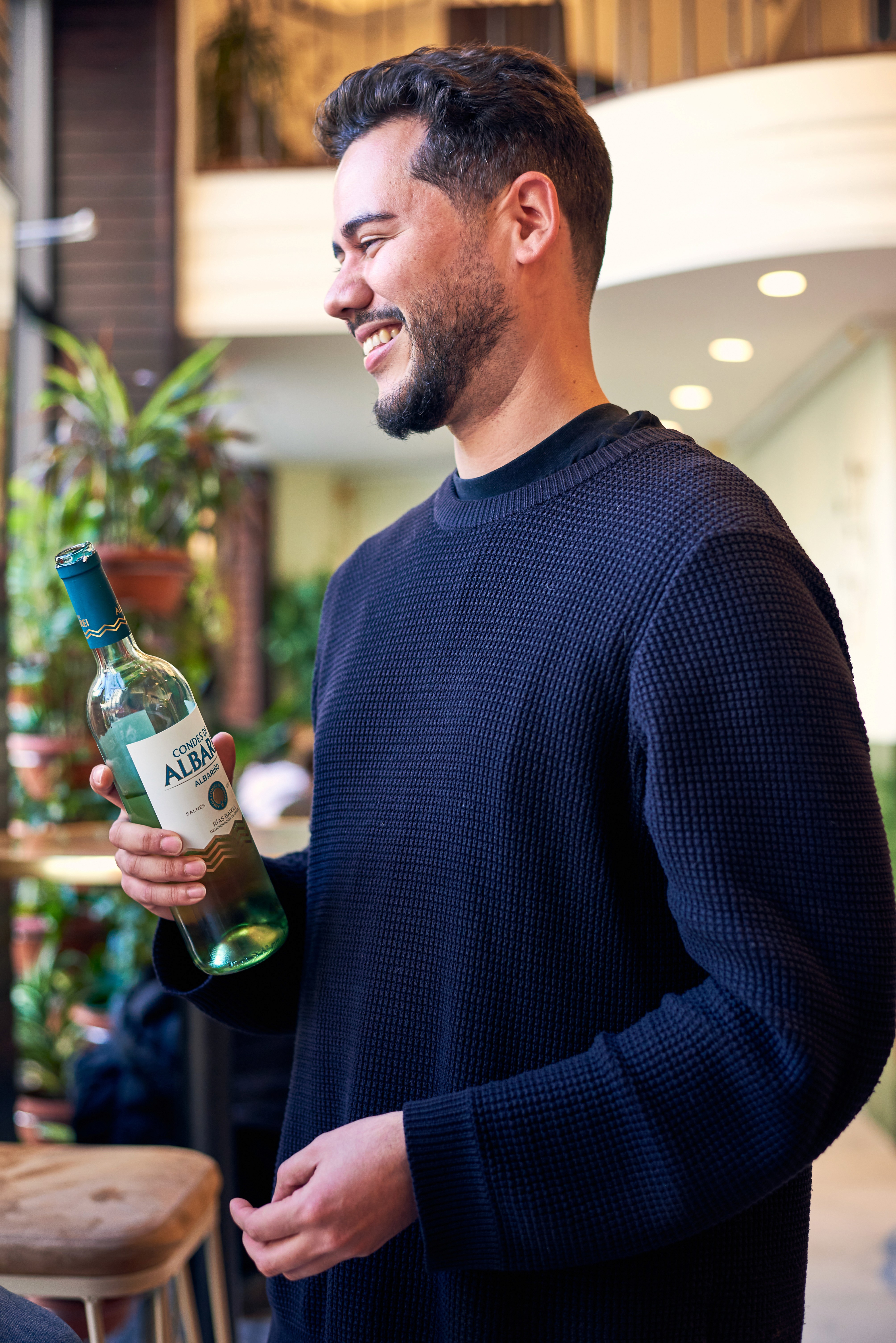 Sommelier presenting a bottle of Spanish wine during a Barcelona wine tasting experience.