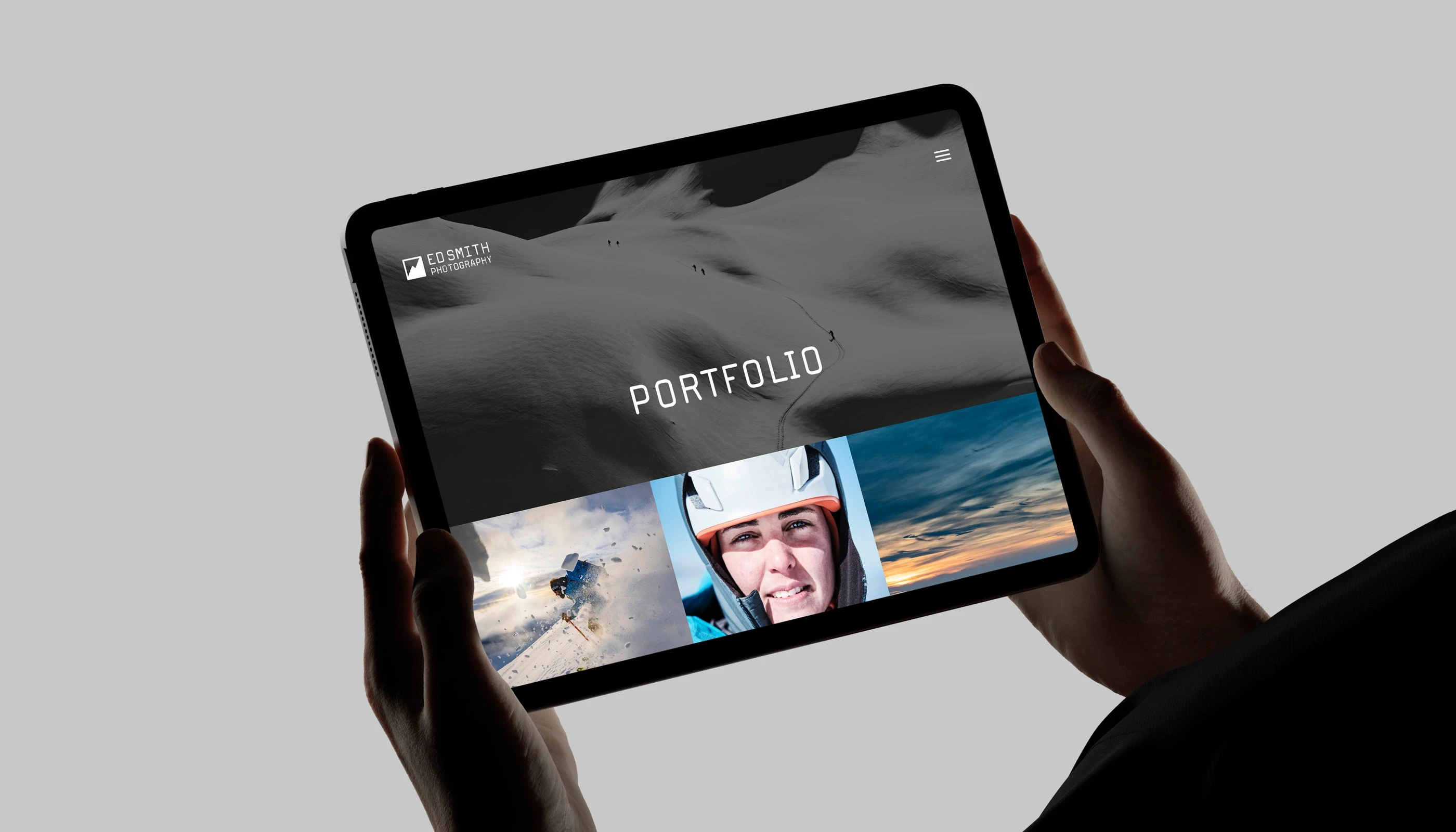 Person holding iPad with Ed Smith's website loaded