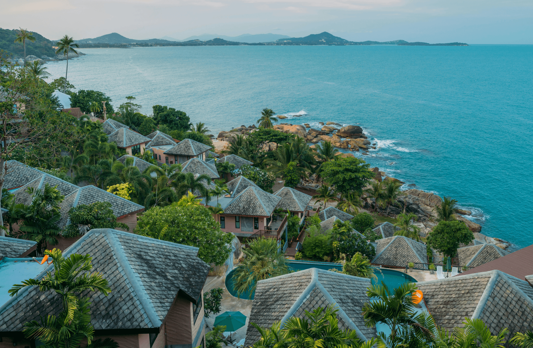 Photo of coastal resort at sunset with ocean and islands in background