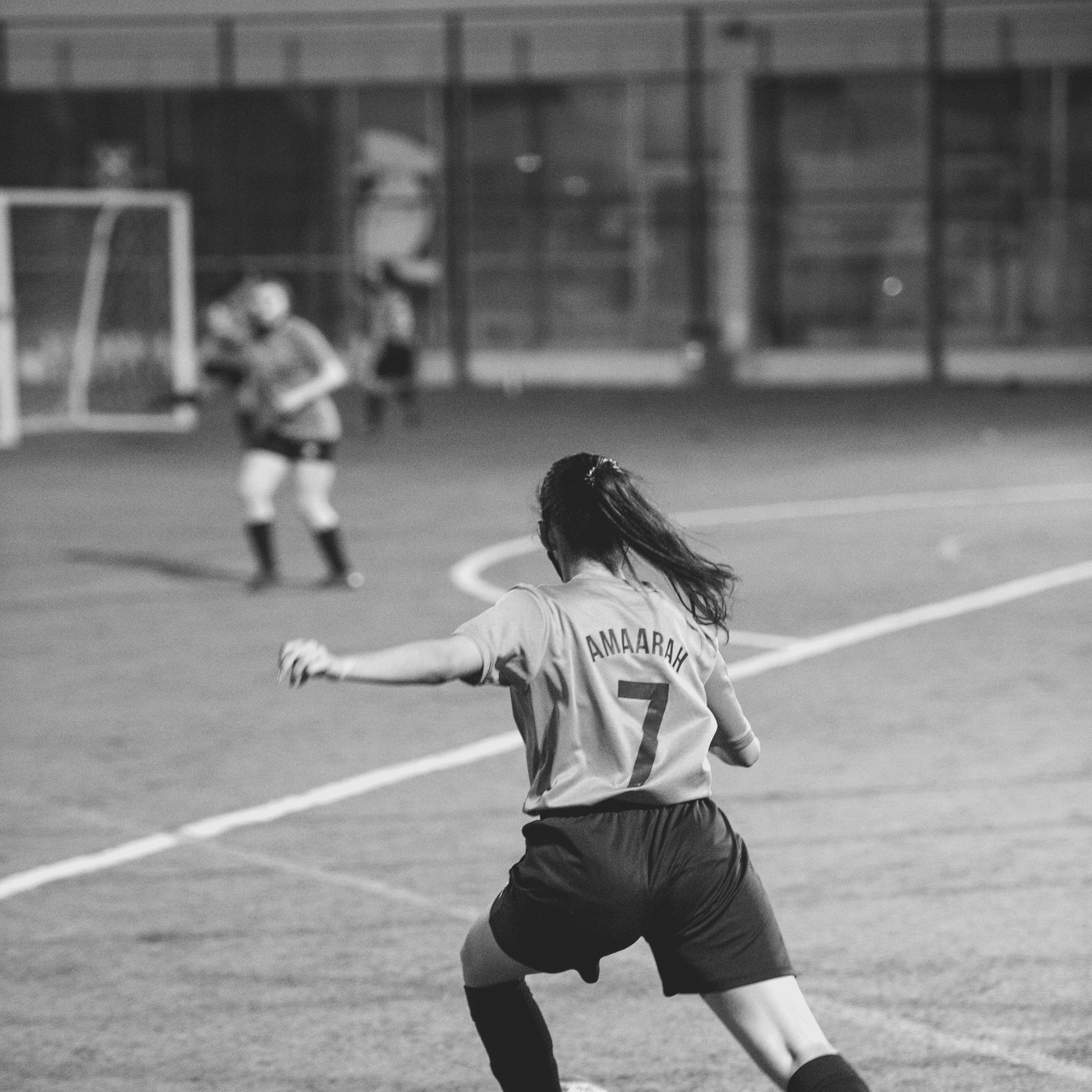 a black and white photo of a woman in a dress