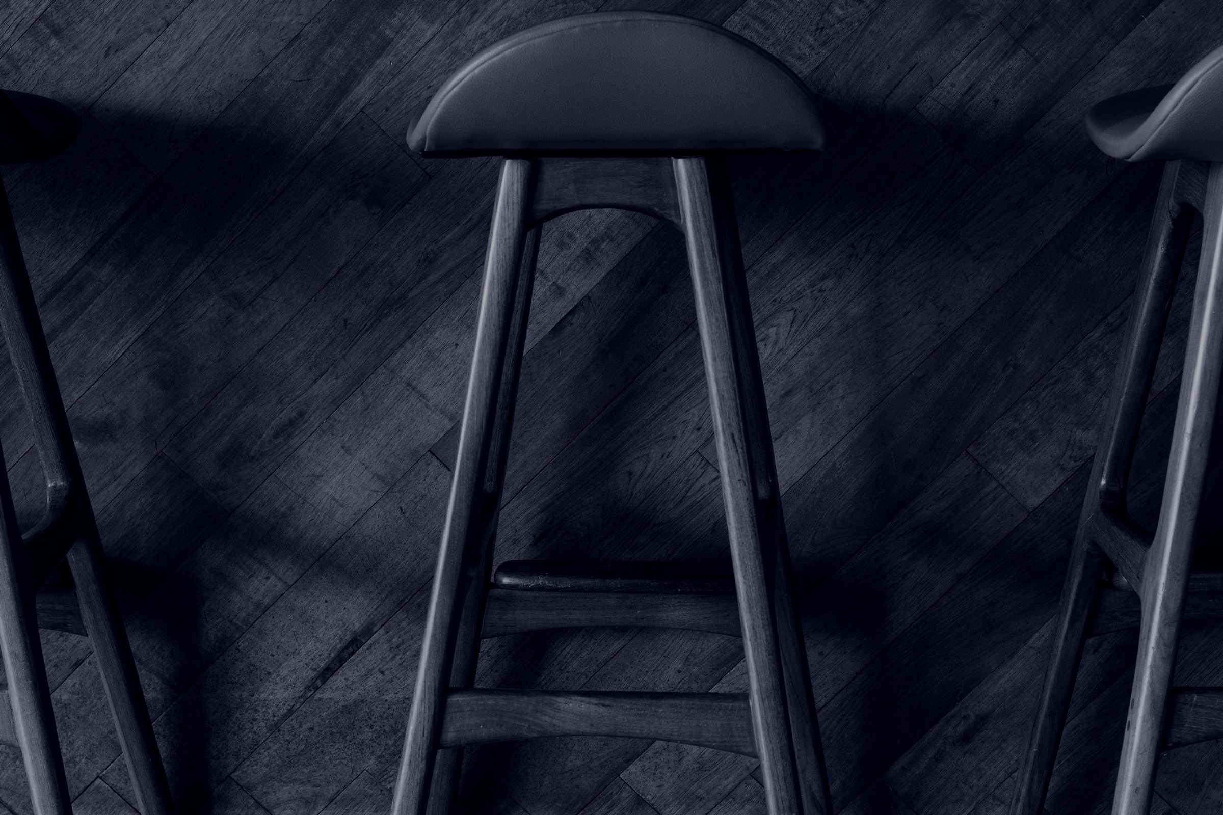 Black and White image of bar stools at bar counter